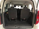 the back of a white van with four black seats in it
