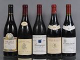 several bottles of wine are lined up on a table