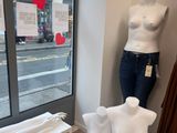 a mannequin in the corner of a clothing store