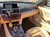 the interior of a car with a steering wheel, dashboard, and a drink holder