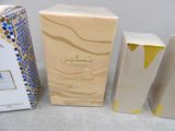 three boxes of perfume sitting next to each other on a table