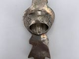 a close up of a metal object on a white surface