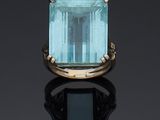 a ring with a blue topaz stone surrounded by pearls