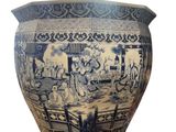 a blue and white vase with a picture of people on it