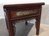 a small wooden table with a drawer on top of it