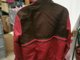 brown and red jacket hanging on a hanger in a room