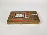 an old nintendo game console sitting on top of a white surface