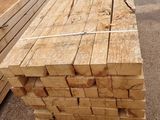 several pieces of wood are stacked on top of each other in a parking lot
