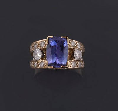 a tan and white gold ring set with a tan sapphire and white diamonds