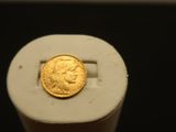 a gold coin sitting on top of a white object