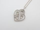 a white gold heart shaped pendant with diamonds on a chain