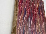 an old book is hanging on the wall with a red and blue striped cover