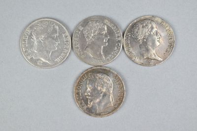 four different types of silver coins on a white surface