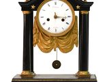 a black and gold clock sitting on top of a table