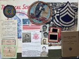 a bulletin board covered with military memorabilia and other items