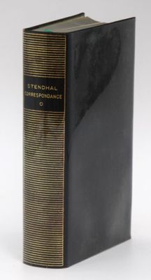a close up of a book on a white surface with a black cover