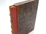 a book that is sitting on a white surface
