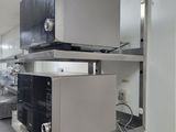 a microwave sitting on top of a shelf in a kitchen