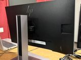 a computer monitor sitting on top of a wooden desk