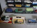 many different types of toy cars on display in a case