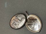a silver locke with a picture of a horse on it