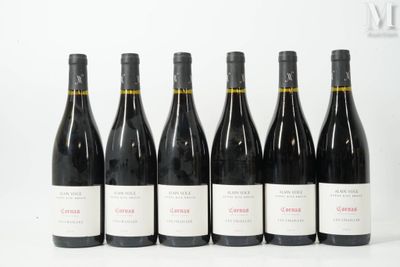 six bottles of wine are lined up on a white surface