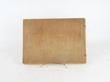 an old book sitting on top of a white surface