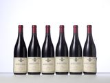 six bottles of red wine lined up in a row