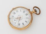 a gold pocket watch with roman numerals on it