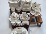 a table with a lot of dishes and cups on it
