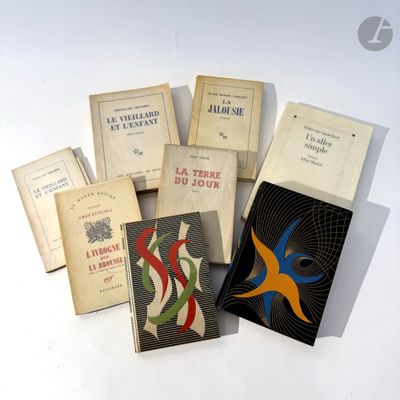several books are stacked on top of each other on a table