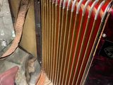an old accordion sitting on a glass table