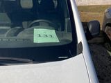 cars parked in a parking lot with a sign on the windshield