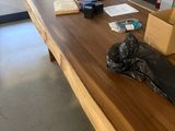 a wooden table with a black bag on top of it
