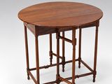 a round table with two legs and a wooden top