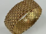 a close up of a gold ring on a white surface