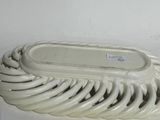 a white plate that has a bunch of white plates on it