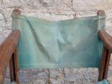 a wooden chair with a green cloth on it