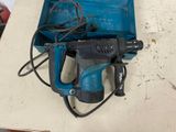 a blue drill and a blue box on a table