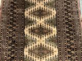 rug on the floor of a room with a blue and white rug on the floor