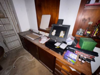 a desk with a laptop computer and other items on it