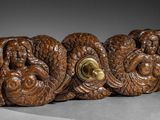 an image of a group of carved wood figures on a gray surface