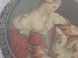 a picture of a woman holding a cat in her lap