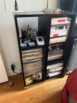 a book shelf that has a bunch of cds on it