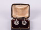 an image of a pair of diamond earrings in a case