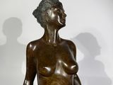 statue of a woman sitting on a black table