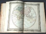 an open book with a map of the world on it