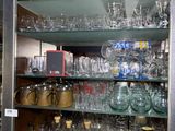 a glass case filled with many different types of glasses