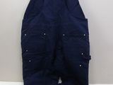 a pair of overalls hanging on a hanger on a wall