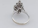 a close up of a diamond ring on a white surface